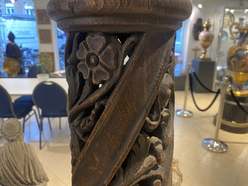 A pair of reticulated carved oak Corinthian columns with cherub heads and vines, 17th C.