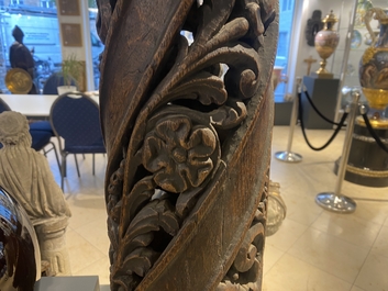 A pair of reticulated carved oak Corinthian columns with cherub heads and vines, 17th C.