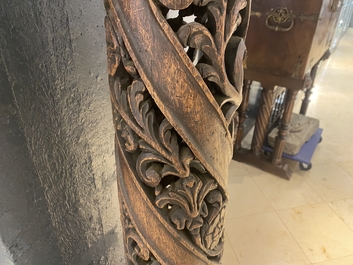 A pair of reticulated carved oak Corinthian columns with cherub heads and vines, 17th C.