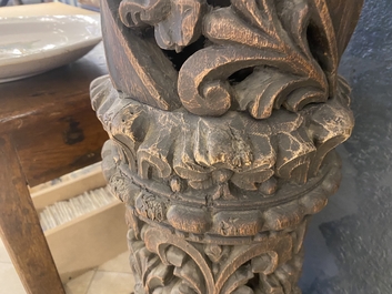 A pair of reticulated carved oak Corinthian columns with cherub heads and vines, 17th C.