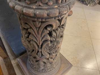 A pair of reticulated carved oak Corinthian columns with cherub heads and vines, 17th C.