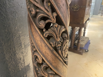 A pair of reticulated carved oak Corinthian columns with cherub heads and vines, 17th C.