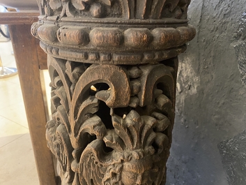 A pair of reticulated carved oak Corinthian columns with cherub heads and vines, 17th C.