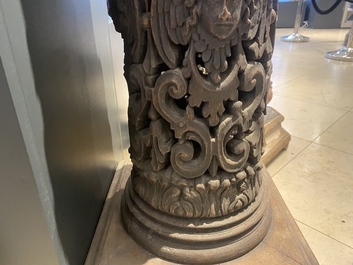 A pair of reticulated carved oak Corinthian columns with cherub heads and vines, 17th C.