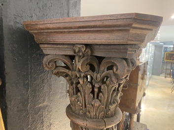 A pair of reticulated carved oak Corinthian columns with cherub heads and vines, 17th C.