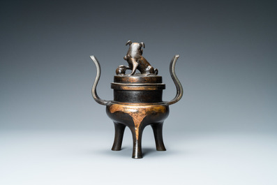 A Chinese partly gilded bronze tripod censer and cover, Ming