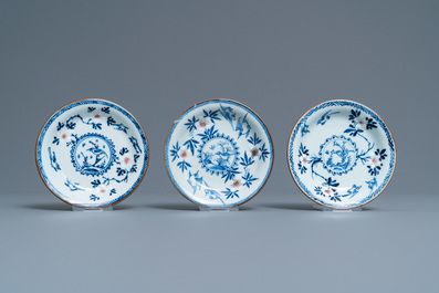Three Chinese blue, white and copper-red cups and saucers, Kangxi