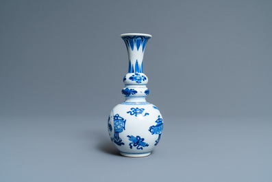 A Chinese blue and white triple gourd 'antiquities' vase, Kangxi