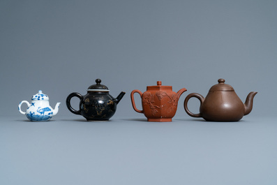 Four Chinese Yixing stoneware, blue and white and monochrome black porcelain teapots, Kangxi and later