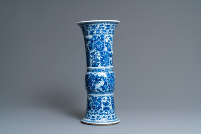 Een Chinese blauw-witte 'gu' vaas met florale en landschapspanelen, Kangxi