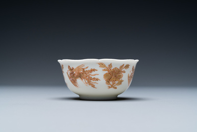 A Chinese iron-red and gilt 'phoenixes' cup and saucer, Kangxi