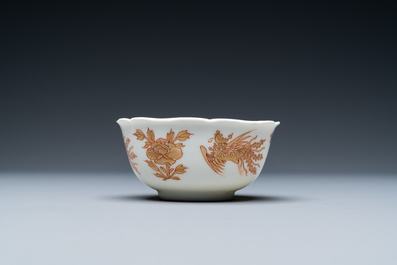A Chinese iron-red and gilt 'phoenixes' cup and saucer, Kangxi