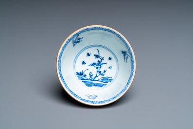 A Chinese blue, white and copper-red cup and saucer, Kangxi