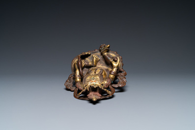 A Sino-Tibetan partly gilt bronze figure of Jambhala with inscriptions on the back, 19th C.