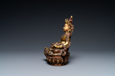 Une figure de Jambhala en bronze partiellement dor&eacute; au dos inscrit, Sino-Tibet, 19&egrave;me