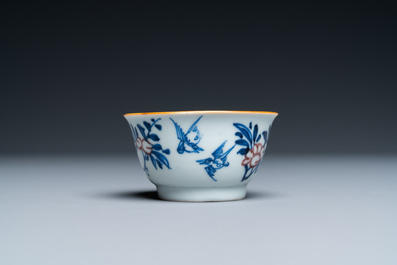 A Chinese blue, white and copper-red cup and saucer, Kangxi