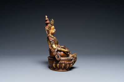 A Sino-Tibetan partly gilt bronze figure of Jambhala with inscriptions on the back, 19th C.