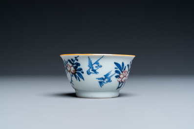 A Chinese blue, white and copper-red cup and saucer, Kangxi