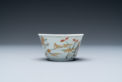 A Chinese grisaille, iron-red and gilt cup and saucer with birds near blossoming branches, Yongzheng