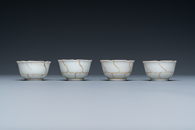 Four Chinese iron-red and gilt cups and saucers and a covered jug, Yongzheng/Qianlong