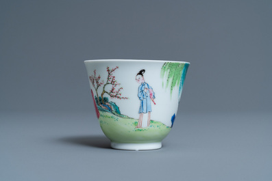 A Chinese famille rose cup and saucer with ladies and a boy playing with a rabbit, Yongzheng