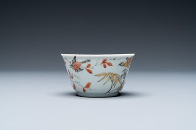 A Chinese grisaille, iron-red and gilt cup and saucer with birds near blossoming branches, Yongzheng