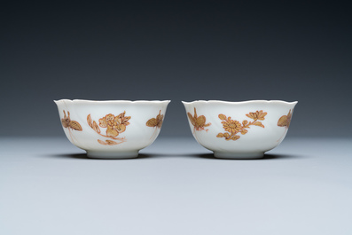 Three Chinese iron-red and gilt 'butterfly' saucers and two cups, Yongzheng