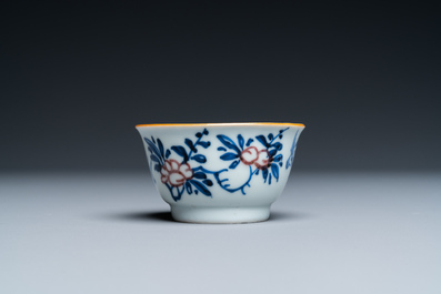 A Chinese blue, white and copper-red cup and saucer, Kangxi