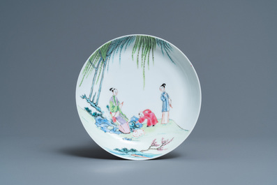 A Chinese famille rose cup and saucer with ladies and a boy playing with a rabbit, Yongzheng