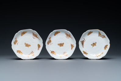 Three Chinese iron-red and gilt 'butterfly' saucers and two cups, Yongzheng
