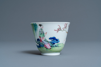 A Chinese famille rose cup and saucer with ladies and a boy playing with a rabbit, Yongzheng