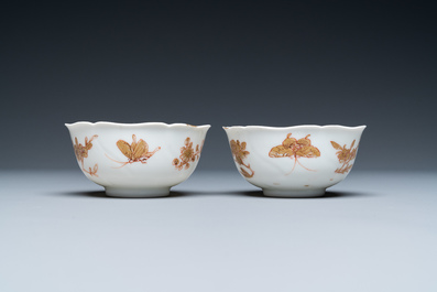 Three Chinese iron-red and gilt 'butterfly' saucers and two cups, Yongzheng