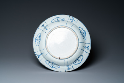 A large Chinese blue and white kraak porcelain dish with figures in a landscape, Wanli