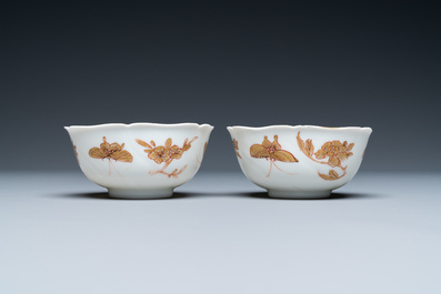 Three Chinese iron-red and gilt 'butterfly' saucers and two cups, Yongzheng