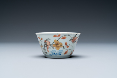 A Chinese grisaille, iron-red and gilt cup and saucer with birds near blossoming branches, Yongzheng