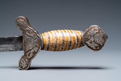 A Tibetan steel sword with silvered copper and mammoth tooth hilt, 19th C.