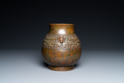 A Chinese bronze 'hu' vase with taotie masks, the base inscribed, 18/19th C.