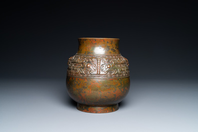 A Chinese bronze 'hu' vase with taotie masks, the base inscribed, 18/19th C.