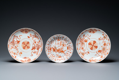A pair of Chinese iron-red and gilt dishes and a lotus-molded plate, Kangxi