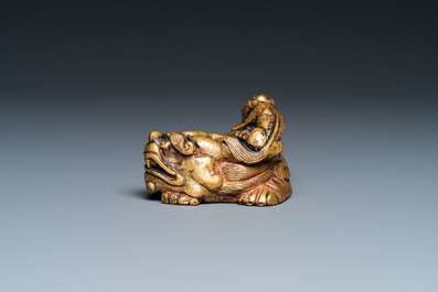 A Chinese gilt bronze 'lion with cubs' scroll weight, Qing