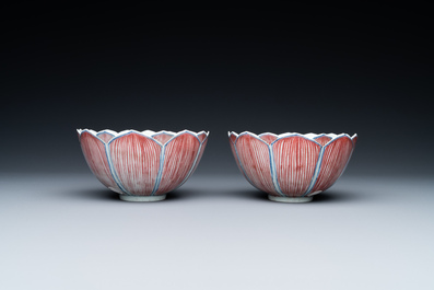 A pair of Chinese blue, white and copper-red 'lotus' bowls, Kangxi mark, 19th C.