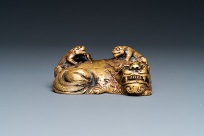 A Chinese gilt bronze 'lion with cubs' scroll weight, Qing