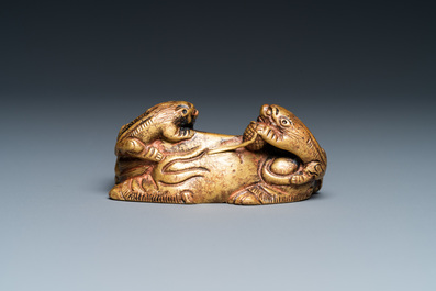 A Chinese gilt bronze 'lion with cubs' scroll weight, Qing