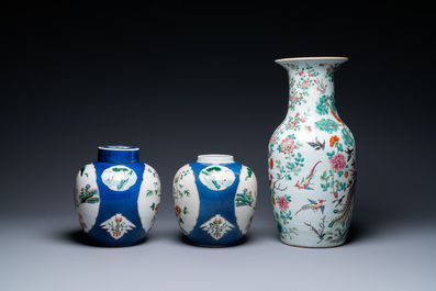 A Chinese famille rose vase and a pair of famille verte powder blue-ground jars, 19th C.