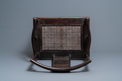 A pair of Chinese carved wooden chairs with wicker seats, 19th C.