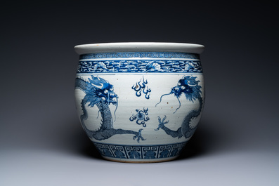 A Chinese blue and white 'dragons' fish bowl, Qianlong/Jiaqing