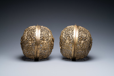 A pair of reticulated Tibetan copper incense balls, 17/18th C.