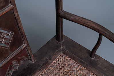 A pair of Chinese carved wooden chairs with wicker seats, 19th C.