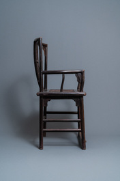 A pair of Chinese carved wooden chairs with wicker seats, 19th C.