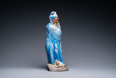 A large Chinese blue-glazed Shiwan pottery 'immortal' figure, 19th C.